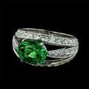 18kt white gold ''Luna'' ring by Gumuchian is set with a vivid green Tsavorite garnet.  The Tsavorite weighs 3.12ct. and is surrounded by pave' set diamonds with a total weight of 1.45ct.  The diamonds are VVS F ideal cut.  12mm width.