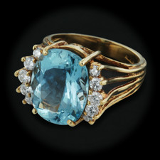 This 18kt yellow gold Ala ring is set with 5.80cts of aqua and  .50 ctw of diamonds with a size of 6.5 and a measurement of 13mm.