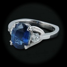 A gorgeous platinum band with a natural fine blue sapphire center stone,
by Krementz.  The oval sapphire measures 10.25 X 7.6mm, and weighs approximately 3.75cts. The ring is set with two diamonds weighing .38ct tw. VS F-G and is a size 6.