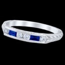 A matching wedding ring for 12AD1. This 14k white gold Edwardian band features 2 channel set baguette shape blue Sapphires. The blue sapphires have a carat weight of 0.15 carats. 4 channel-set round diamonds, finshed with beautifully hand cut engraving.