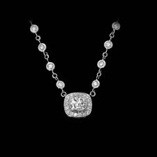 This gorgeous platinum and diamond Michael Beaudry pendant suspends a .68ct cushion-shaped diamond with a .14ctw diamond border. Call for price and availability.