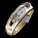 A 1970's Vintage 14kt Yellow Gold Diamond ring and wedding Band.  
The Ring Is Channel Set With 5 Full Cut Round Diamonds Weighing Approximately .35 Ct.  Si-i Clarity White Colors.  
Ring Is A Size 8 3/4, Weighs 6.8 Grams, And Is 6.2mm Width Tapering To 3.5mm.  Nice Condition!

