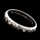 This is an 18kt white gold diamond wedding band from the Charles Green collection. This ring is beautifully engraved and set with .18ctw of diamonds.