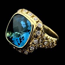 Ladies 18kt. green gold SeidenGang ring set with a large light blue topaz. The ring is accented with .72ctw in diamonds around the bezel and shank.
