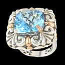 A beautifully detailed sterling silver and 18K gold blue topaz ring from Bellarri. The blue topaz has a size of 14.55tcw.. The signiture "B" has two small diamonds that have a total carat weight of 0.01. 