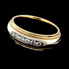 A beautiful diamond wedding band in 18kt white and yellow gold with six channel set diamonds. We have carried this classic for 25 years. The ring is made by Jabel and contains .30ctw of fine diamonds.