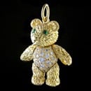 A adorable 18kt gold diamond and emerald bear charm. This solid 7/8'' is set with sapphires and emeralds.  Legs, arms, and head moves.  Made in the USA.  A 1 1/18th inch larger size is available