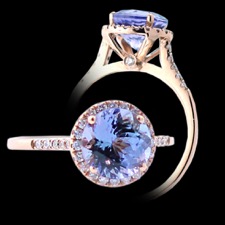 Beautiful little 14 karat rose gold ring. The ring is centered with a round faceted blue sapphire weighing 2.65 carats. Set around the center are twenty round brilliant cut diamonds. There are ten round brilliant cut diamonds in the shanks shoulders, five on either side of center. The preceding diamonds are bead set. Set underneath the center head and bezel set are two round brilliant cut diamonds, one on either side. The round diamonds have a weight of 0.16 carats in total. This ring could be worn as a stand alone or as a engagement ring.  