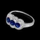 This beautiful 18k white gold Beverley K engagement ring is studded with diamonds and features three round sapphire center stones. This ring can be worn as a right hand ring or makes for a stunning wedding ring. The total diamond weight is 0.21 carats. This ring as shown is set with 1.09ct of fine blue sapphires. The surfaces feature engraving with milgrained edges. The ring is also available in platinum. 
