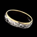 A distinctive 18kt two-tone gold wedding band from the Charles Green collection. this engraved ring with an enchanting ivy and leaf design will capture attention. Carved by hand, the ring measures 5.0mm in width.