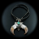 (SOLD) A rare bear claw necklace with sterling silver, black coral, and a veiny turquoise stone. The 1940's vintage piece is in excellent condition and the chain measures 19" long. The pendant measures 2 3/4" wide and 2 1/4" tall. 

We are pleased to offer a huge assortment of fine vintage sterling silver and turquoise jewelry originating from a large southwest estate. 
A great native american necklace