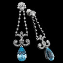 Elegantly designed cocktail earrings handcrafted in 18k white gold, set with 1.18ctw of diamonds and 10.00 carats of blue topaz. Rose-cut diamonds are set in the larger bezels at top, center, and bottom.