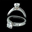 A gorgeous platinum and diamond engagement ring. The piece, designed by Jeff Cooper contains .33cts of round brilliant and baguette cut side diamond. The four prong head will accommodate a 6.30mm round stone, and the finger size is 5.75.