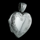 A beautiful hand-engraved 18 kt. white gold heart shaped locket from English jeweler Charles Green. This is sure to be a highly worn pendant for now as well as for the future generations.  23mm x 21mm. Hand forged
