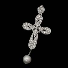 This beautiful cross pendant is available in white or yellow 14kt gold and features diamond detailing and a beautiful drop pearl.