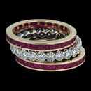Eternity channel set princess cut ruby wedding ring from Spark. The ring is set with 1.45 carats total weight in 18K yellow gold. Shown with a bezel-set eternity band, 1.6mm, with .48 carats total weight in round diamonds in 18K gold. Also available in tsavorite garnet and yellow sapphire.