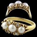 A Charles Green 18k yellow gold Victorian pearl and diamond ring.  This solid  ring is set with a center 5mm cultured pearl with side pearls measuring 4mm each.  The ring has 4 full cut diamonds weighing .08ct total.  VS clarity, G-H color. Ring weighs 6.2 grams.  Very fine English made piece.