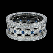 Gorgeous diamond and sapphire flower wedding band in platinum by Michael Beaudry.  Handmade this ring measures 9mm in width. 1.0ct diamonds and .50ct sapphire.  This was a custom created piece.  Finger size 6.75 in stock.