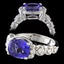 A beautiful platinum, Tanzanite, and diamond ring.  The ring is set with an intense purplish blue oval faceted tanzanite weighing 2.95 carats.  Set on each side of center are 6 round brilliant cut diamonds, twelve in total, with a total weight of .30ct.  The diamonds are VVS in clarity and  E-F in color. This is a stunning ring with an eye catching color and design. 